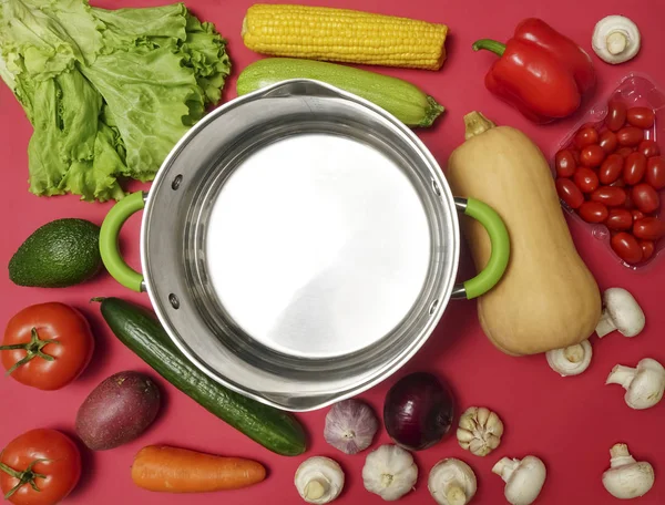 Fresh vegetables on red table background. place for text. empty sauce pan — Stock Image Fresh Vegetables Red Table Background Place Text Empty Sauce Pan Stock Picture