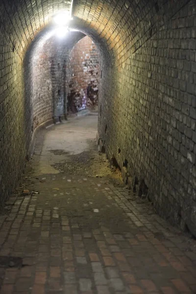 Brick Tunnel . Dark long corridor lined with bricks old passage