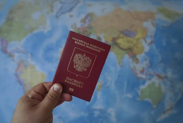 Russian Passport Traveling Abroad World Map Background Hand Holding Red — Stockfoto