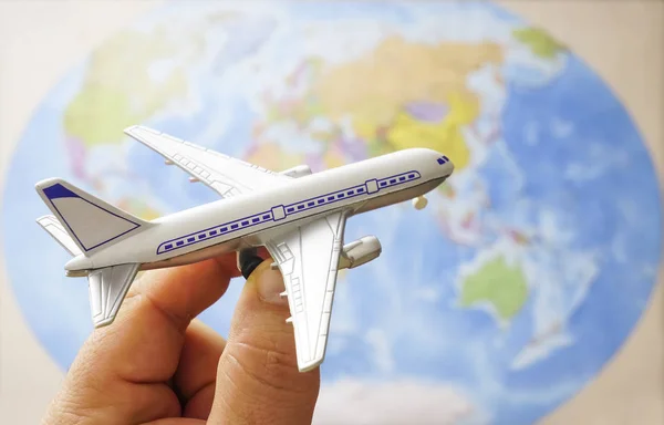 Erkek Tutmak Harita Arka Plan Üzerinde Uçak Oyuncak — Stok fotoğraf