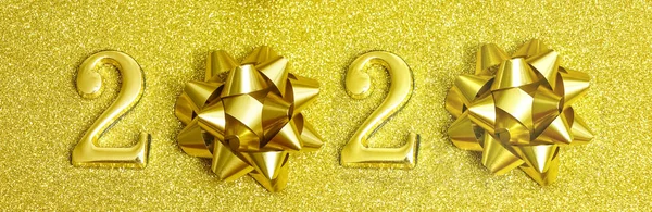 Happy new year. Gold Festive Number  Design. yellow texture. Gold shining glitter confetti. Happy New Year Banner with 2020 Number