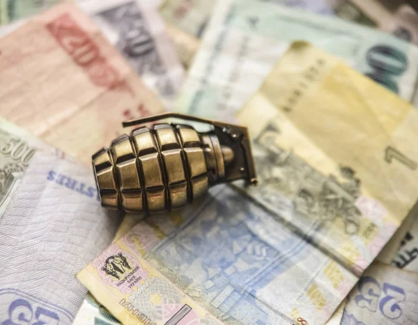 Money for War Concept Hand Grenade and Money bill from different countries