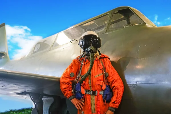 jet fighter pilot helmet. dummy of an airplane pilot in a helmet and overalls against the background of an airplane