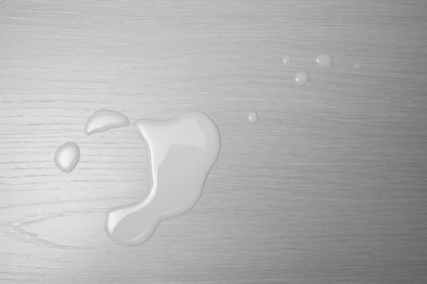 spilled milk on wooden table. top view. food background.
