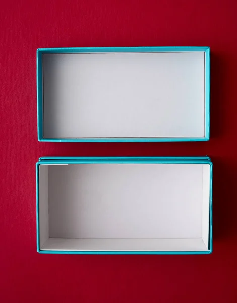 empty cartoon box with cover isolated on red background.