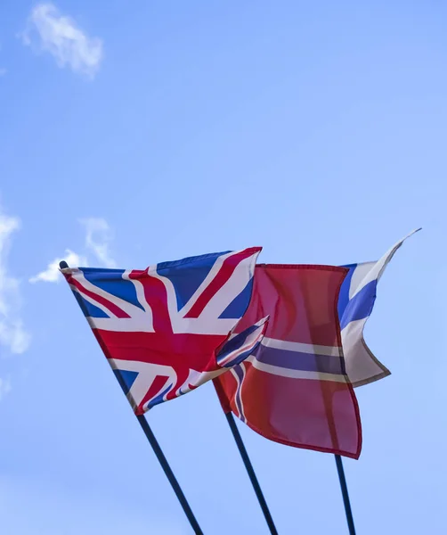 Norway, finland, Sweden and UK - nationals flags on blue sky background. embassy building