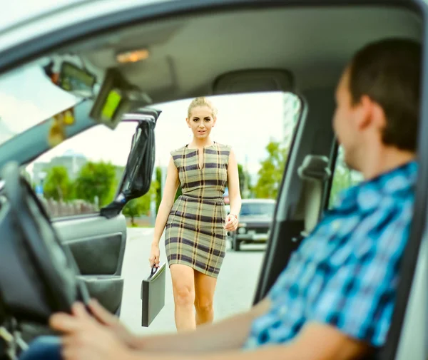 personal driver. A pretty business woman getting into a taxi cab