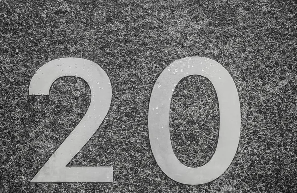 Number Twenty 20 - Door Number in Metal on a Stone Wall