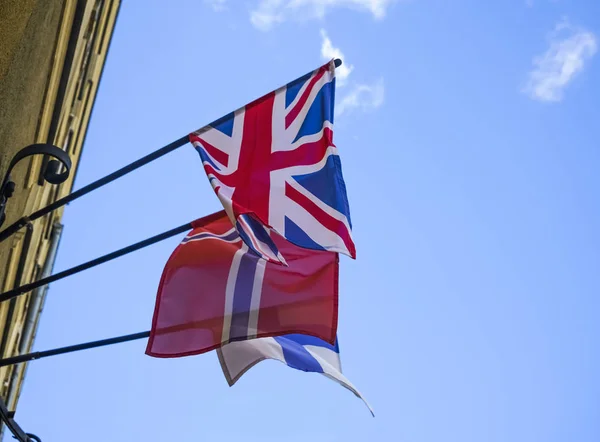 Norway, finland, Sweden and UK - nationals flags on blue sky background. embassy building