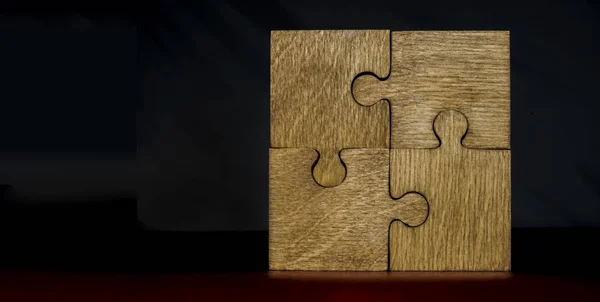 Four Wooden Puzzle Pieces Black Background Concept Connection People — Stock Photo, Image