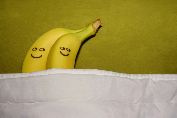 couple of Bananas hugging  in bed.  happy together