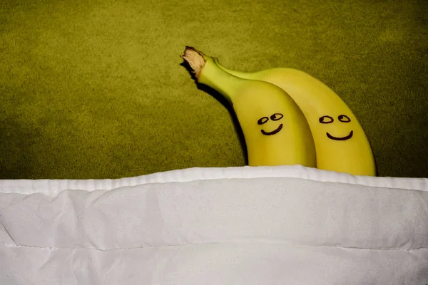 couple of Bananas hugging  in bed.  happy together