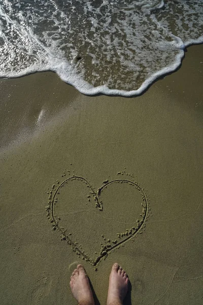 A Heart In The Sand With  Feet.