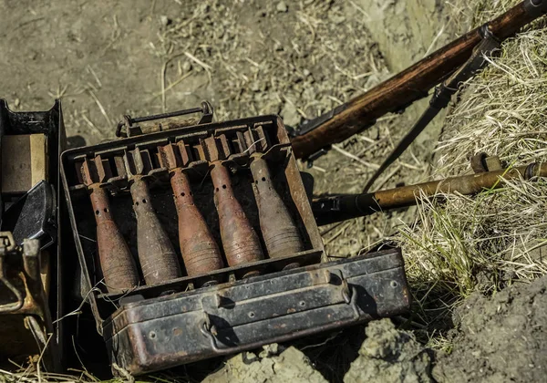 Rusty mortar shells in the metal box. mortar mine and a hand grenade launcher at the stand. Weapons of war in Ukraine