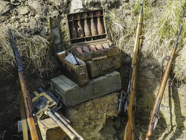 Rusty mortar shells in the metal box. mortar mine and a hand grenade launcher at the stand. Weapons of war in Ukraine