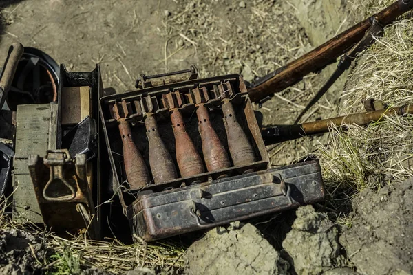 Rusty mortar shells in the metal box. mortar mine and a hand grenade launcher at the stand. Weapons of war in Ukraine