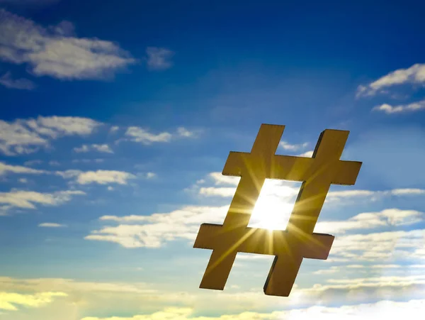 closeup of wooden sign in the shape of a hash tag symbol against the sky, with some blank space. hashtag