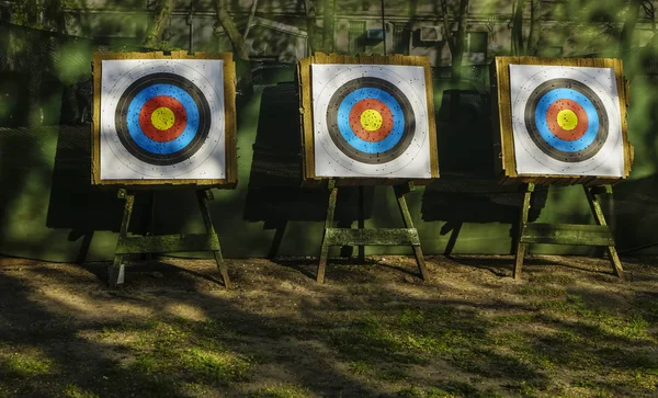 shooting range. three targets for practicing archery outdoors with bullet holes in the shooting