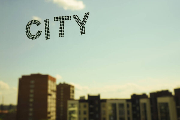 word - city on blue sky and highrise buildings background. 