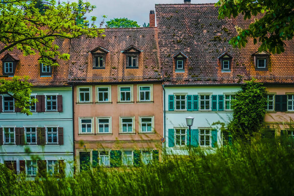 Town view. Sunny day, summer park, trees, green grass, historical buildings, Europe tourist attractions. Bamberg, Germany.