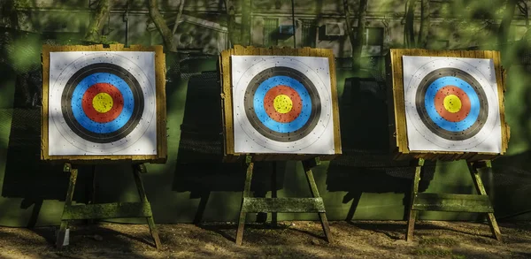 shooting range. three targets for practicing archery outdoors with bullet holes in the shooting