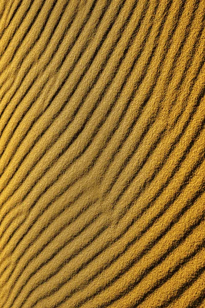 Sand pattern, interesting abstract texture. top view. beach Sand texture in Gold desert