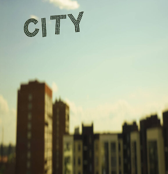 word - city on blue sky and highrise buildings background. 