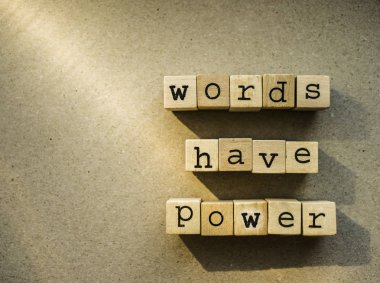 words  Words Have Power written in  wooden alphabet letters isolated on an craft paper - carton background with empty copy space. ray of sunshine clipart