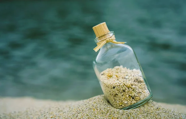 Bottle Seashells Buried White Sand Summer Beach Blue Water Background — Stock Photo, Image