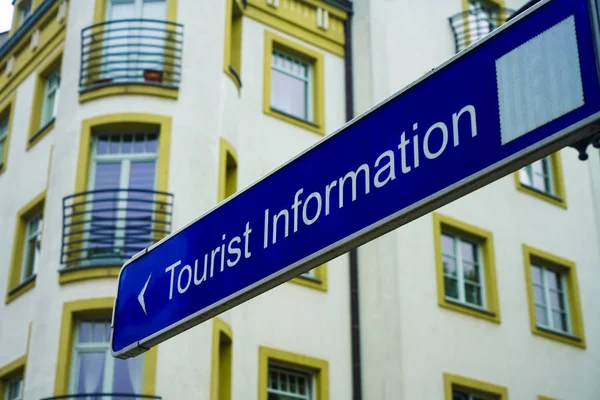 tourist information, guided tours arrow signs. Blue Tourist Information directional sign.