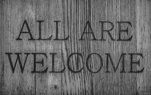 Words - all are welcome. burn out  letters on the wood board