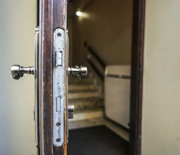 Open wooden door close-up. Mortise lock in the door.