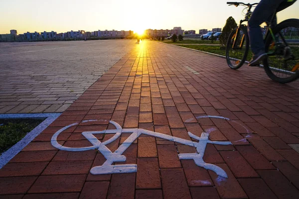 Bikes Lane Symbol and Cyclist. cyclist runs by a separate bike lane.Bicycle and Bike Symbol Sign on Street