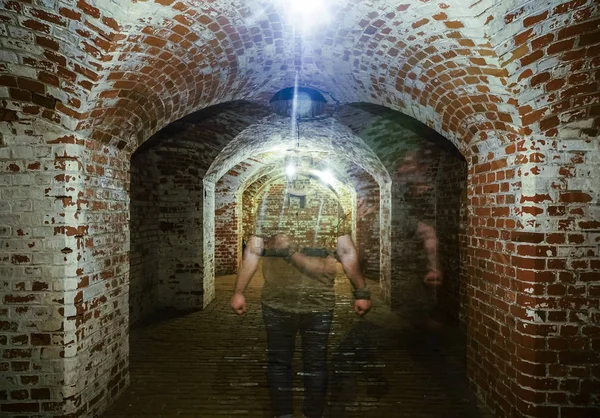 Man is walking through dark underground.movement effect rushing through space view and flight speed background blur effect flying brick arch