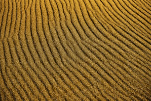 Sand pattern, interesting abstract texture. top view. beach Sand texture in Gold desert