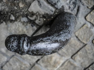 iron penis at the base of the building in Krakow