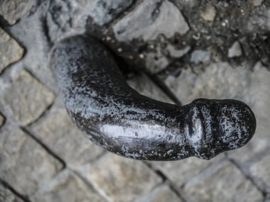 iron penis at the base of the building in Krakow