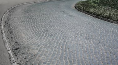 Dairesel desenli arnavut kaldırım taşları ile rögar kapağı, perspektif çekim. perspektifte boş yol. 