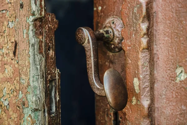 Picture of old rusty latch.old wooden entrance door with antique door handle