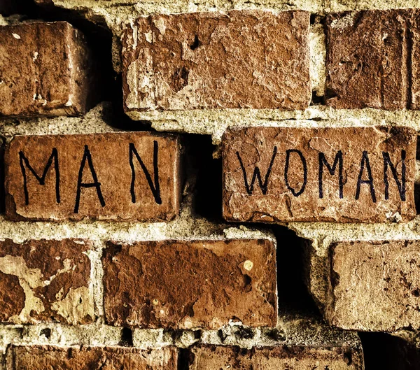 Words Man Woman Running Different Directions Background Broken Brick Wall — Stock Photo, Image
