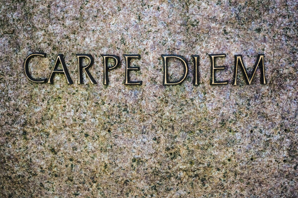  metal words on Stone background with phrase -  Carpe Diem -  text