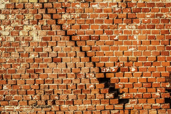 Deep crack in old brick wall - concept image. Broken wall.