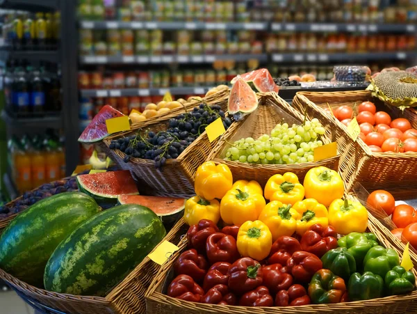 raw fresh vegetables, berries and fruits.  grocery store, shop. wicker baskets. food background.