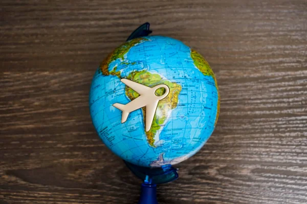 Travel with plane, small toy plain on globe map background, traveling and logistic  concept