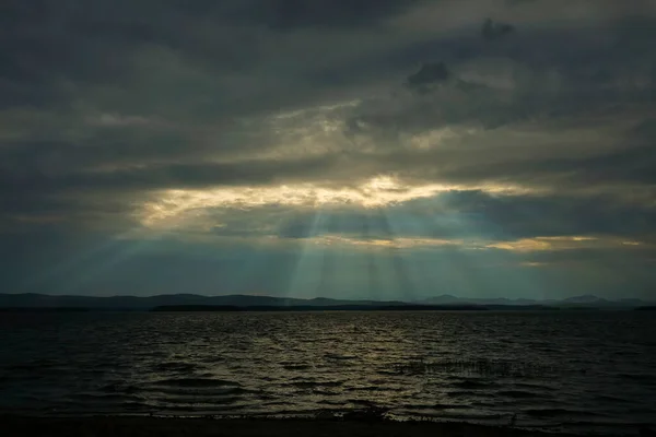 Sun rays over valley. Sun rays over hill.