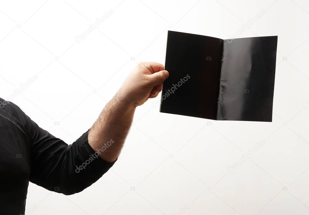male  hand holding black  blank book for reader with copy space. isolated  on white  background
