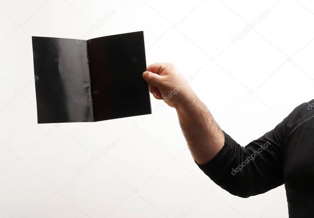 male  hand holding black  blank book  with copy space. isolated  on white  background