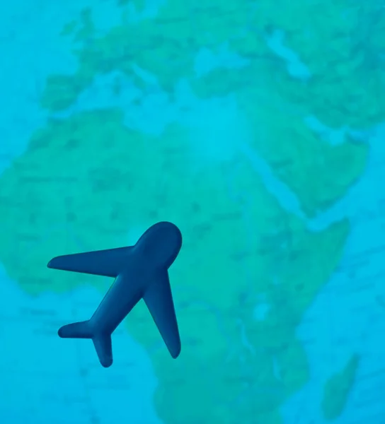 Travel with plane, small toy plain on globe map background, traveling and logistic  concept