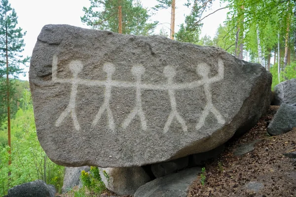 ancient men, an image of ocher on the wall of rocks. Ancient evolution, people are dancing a ritual dance. South Ural of the Stone Age. Archeology. history.