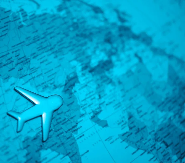 Travel with plane, small toy plain on globe map background, traveling and logistic  concept